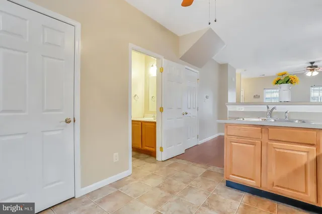 a spacious bathroom with a granite countertop sink a mirror a vanity and a bathtub