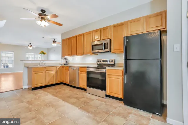 a kitchen with a sink stainless steel appliances and cabinets