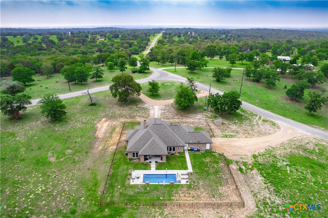 494 Flash Circle Luling, TX 78648 - Photo 40 of 44 a view of a garden with a building in the background