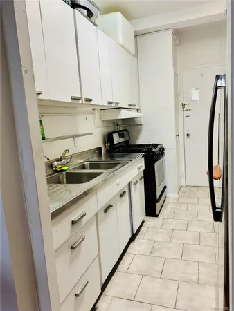 a kitchen with stainless steel appliances a stove a refrigerator and cabinets