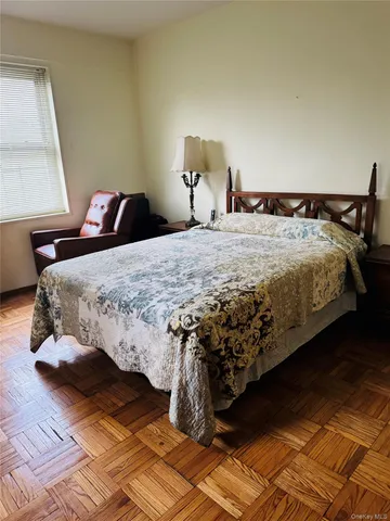 a bedroom with bed and window
