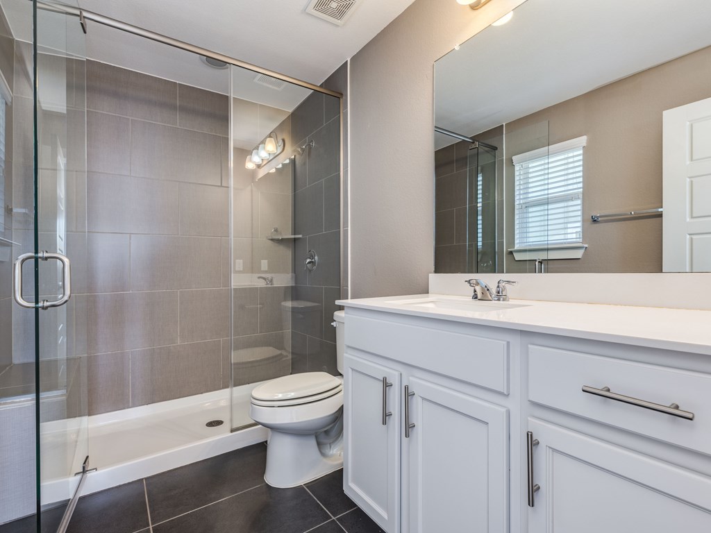 2208 Capulet Street Austin, TX 78741 - Photo 14 of 23 a bathroom with a sink a toilet and shower