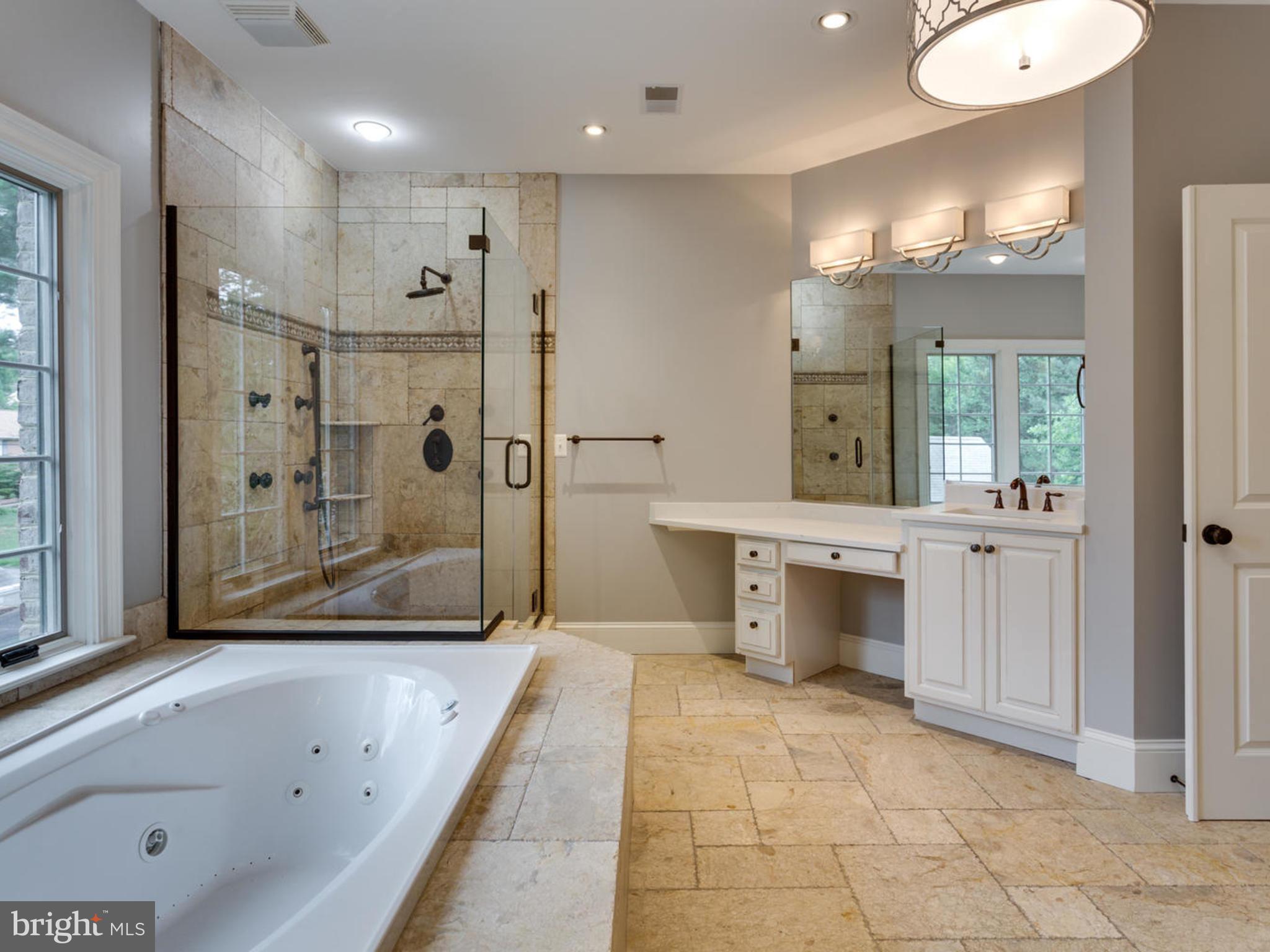 6906 Chelsea Road McLean, VA 22101 - Photo 15 of 25 a bathroom with a tub a sink shower and mirror
