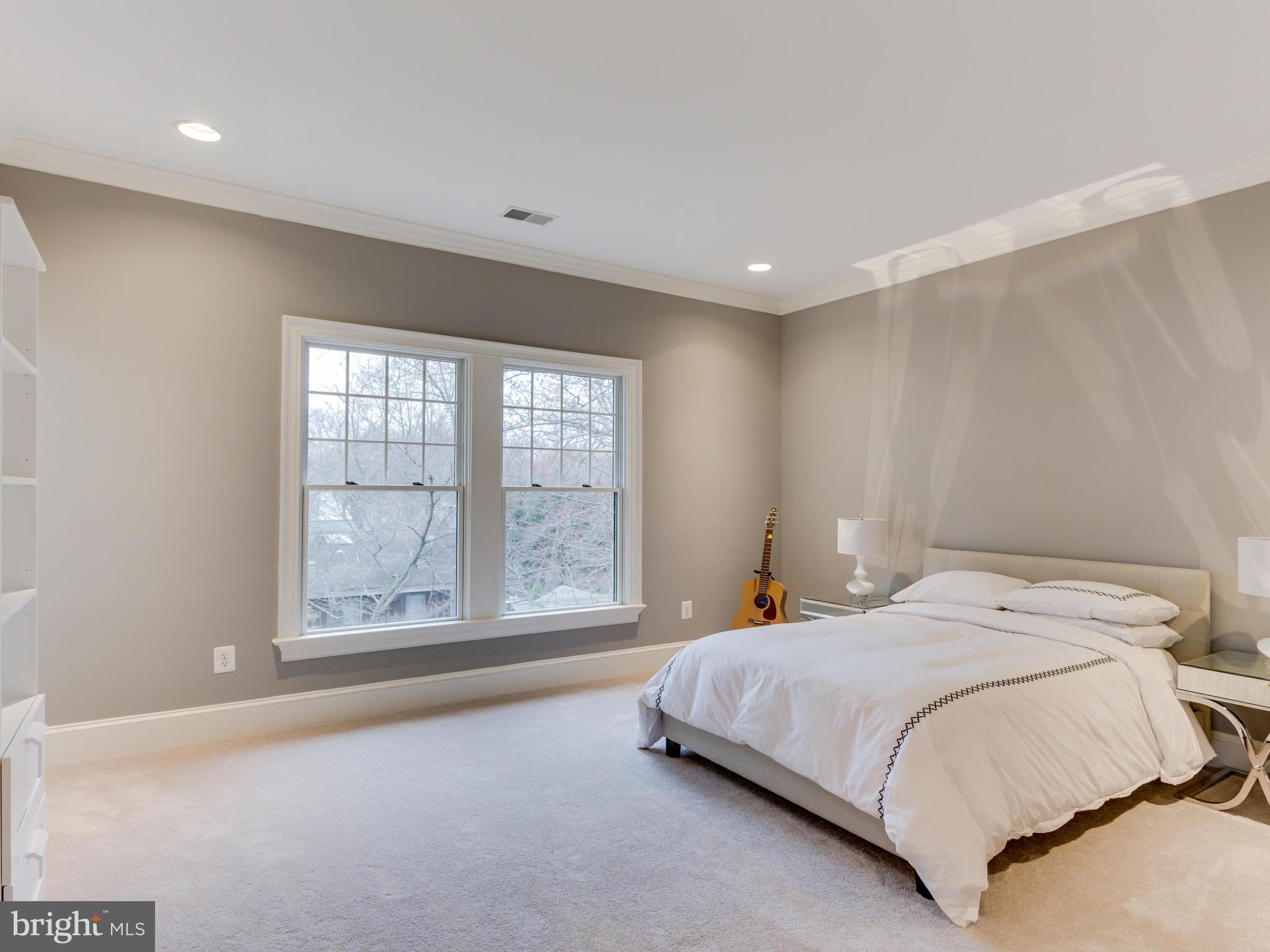 6906 Chelsea Road McLean, VA 22101 - Photo 18 of 25 a bedroom with a bed and a large window