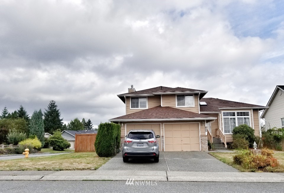 809 234th Street Southeast Bothell, WA 98021 - Photo 1 of 11 a car parked in front of a house