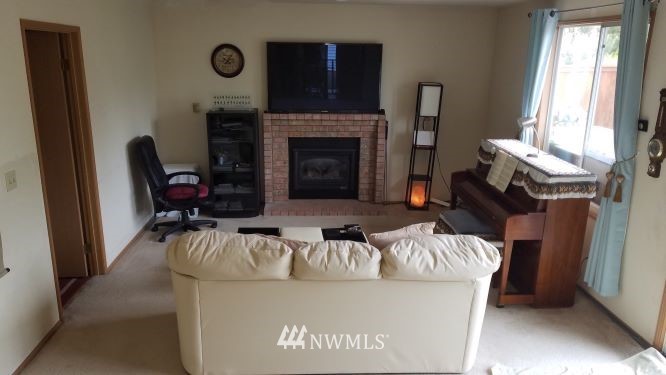 809 234th Street Southeast Bothell, WA 98021 - Photo 2 of 11 a living room with furniture and a fireplace