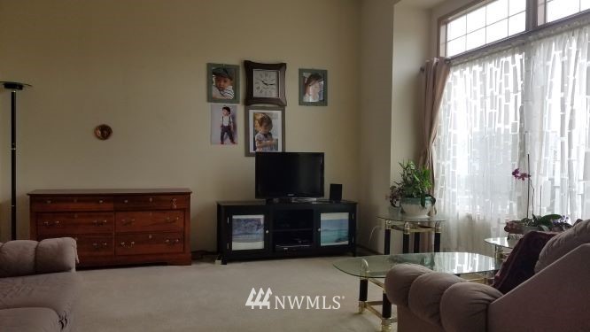 809 234th Street Southeast Bothell, WA 98021 - Photo 3 of 11 a living room with furniture a flat screen tv and a fireplace