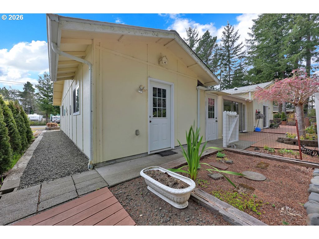 1415 20th Street Florence, OR 97439 - Photo 40 of 40 a view of a backyard with plants and a patio