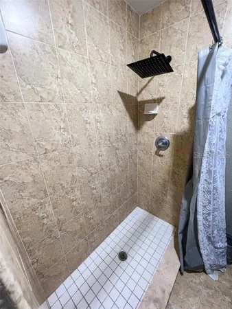 a bedroom with furniture and a chandelier