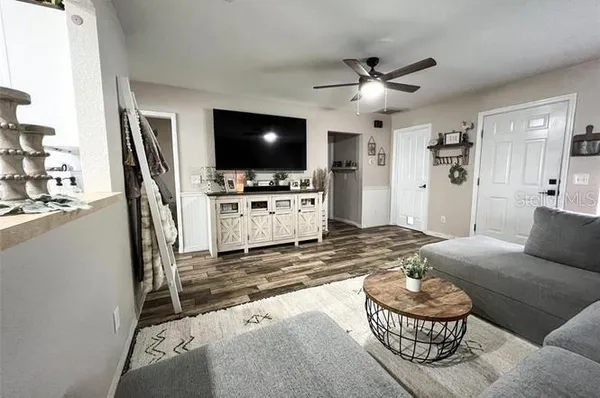 a kitchen with refrigerator a sink dining table and chairs