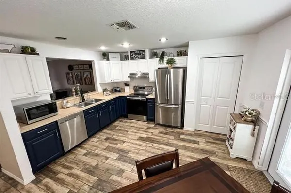 a large kitchen with a table and chairs