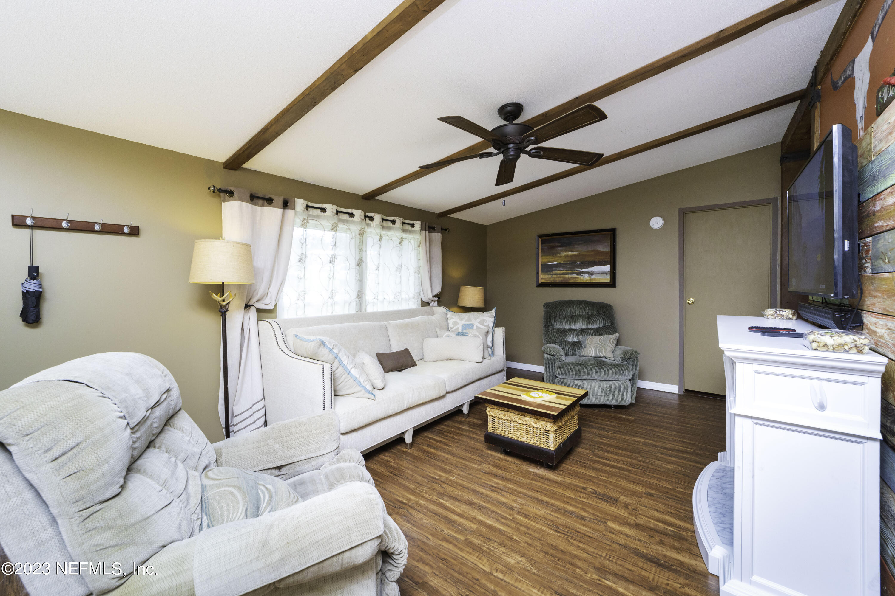 103 Long Branch Court Interlachen, FL 32148 - Photo 16 of 54 a living room with furniture and a wooden floor