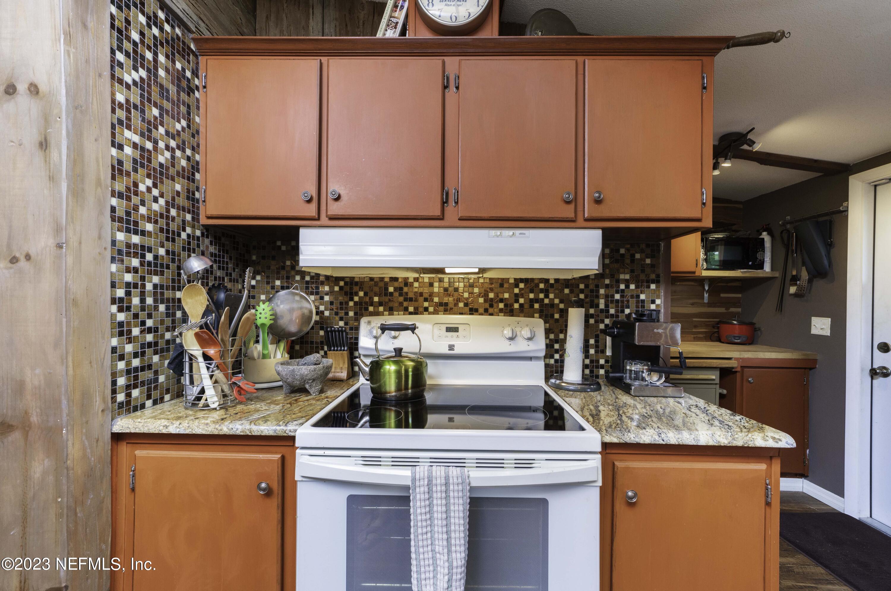 103 Long Branch Court Interlachen, FL 32148 - Photo 24 of 54 a kitchen with stainless steel appliances granite countertop a stove and a refrigerator