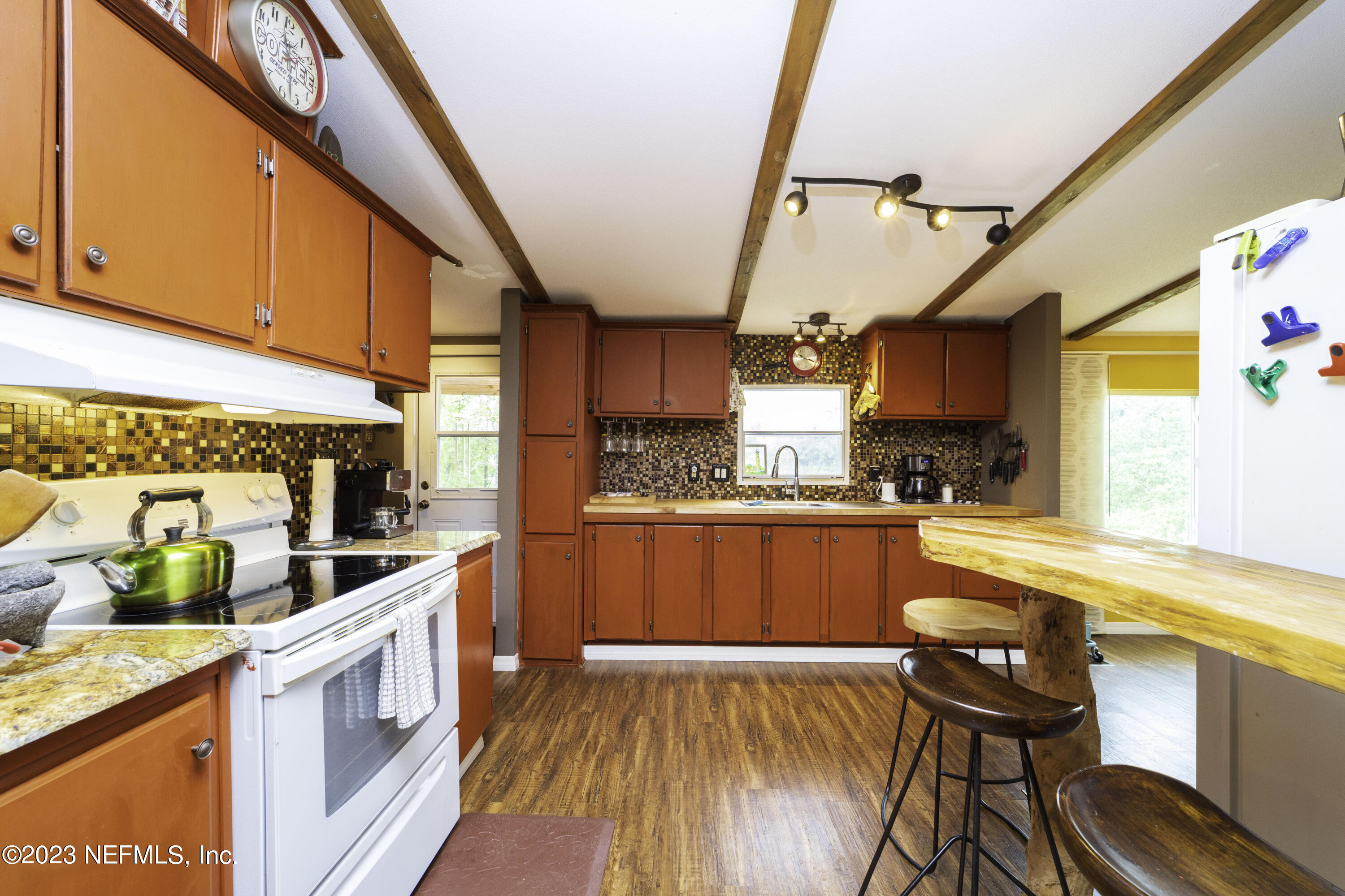 103 Long Branch Court Interlachen, FL 32148 - Photo 25 of 54 a kitchen with stainless steel appliances wooden floors and wooden cabinets