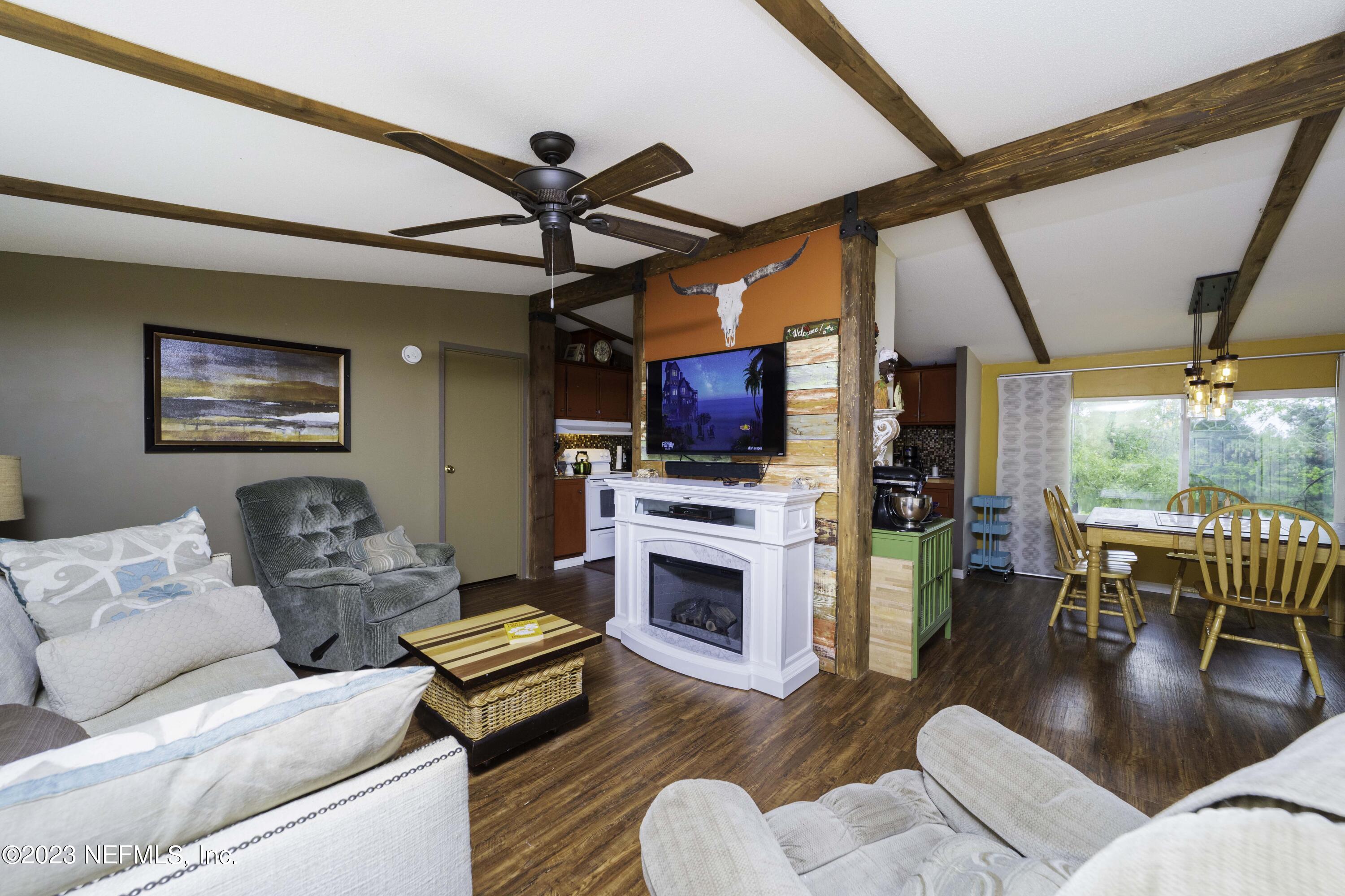 103 Long Branch Court Interlachen, FL 32148 - Photo 3 of 54 a living room with fireplace furniture and a flat screen tv