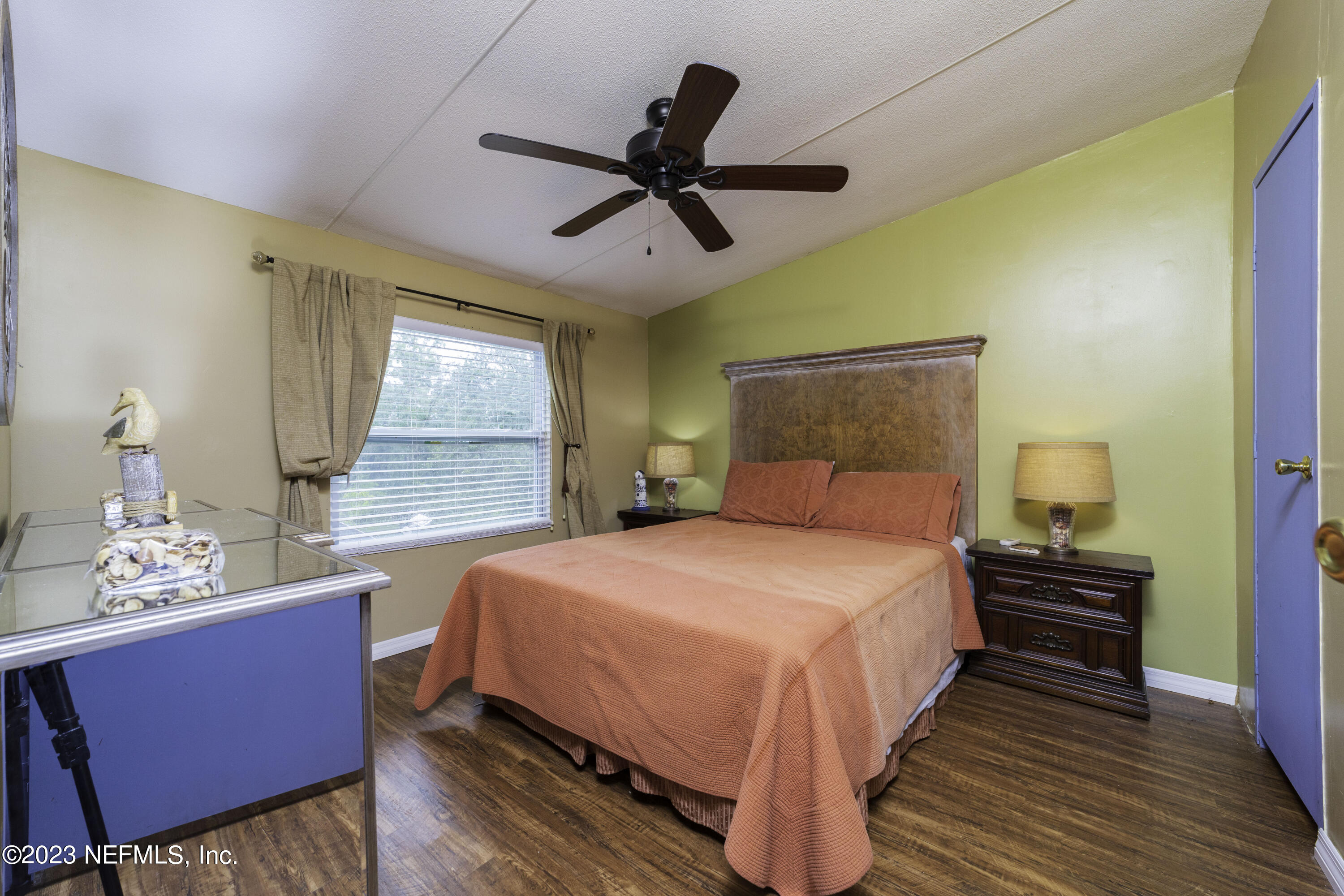 103 Long Branch Court Interlachen, FL 32148 - Photo 39 of 54 a bedroom with a bed a chandelier and a window