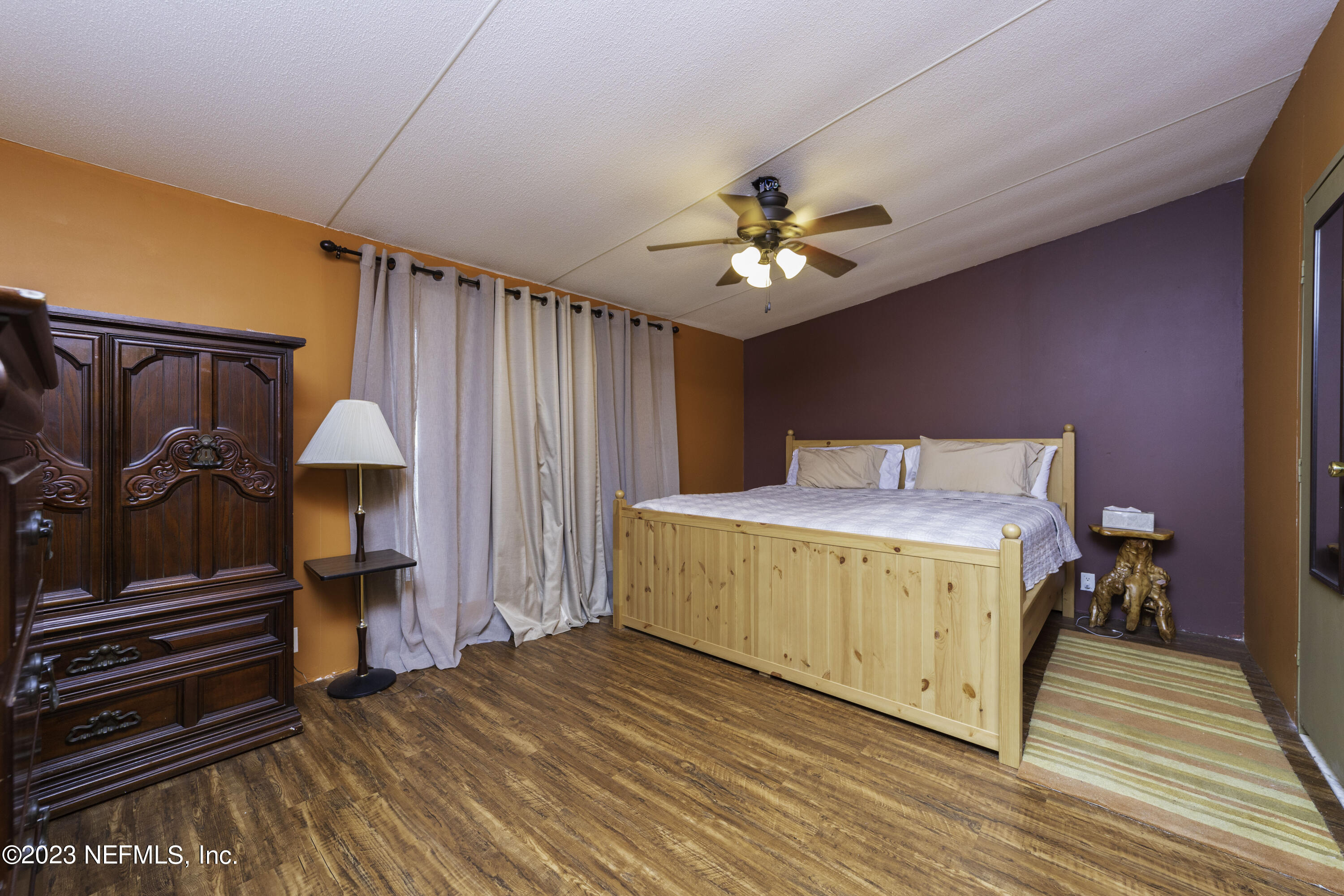 103 Long Branch Court Interlachen, FL 32148 - Photo 42 of 54 a spacious bedroom with a bed and wooden floor