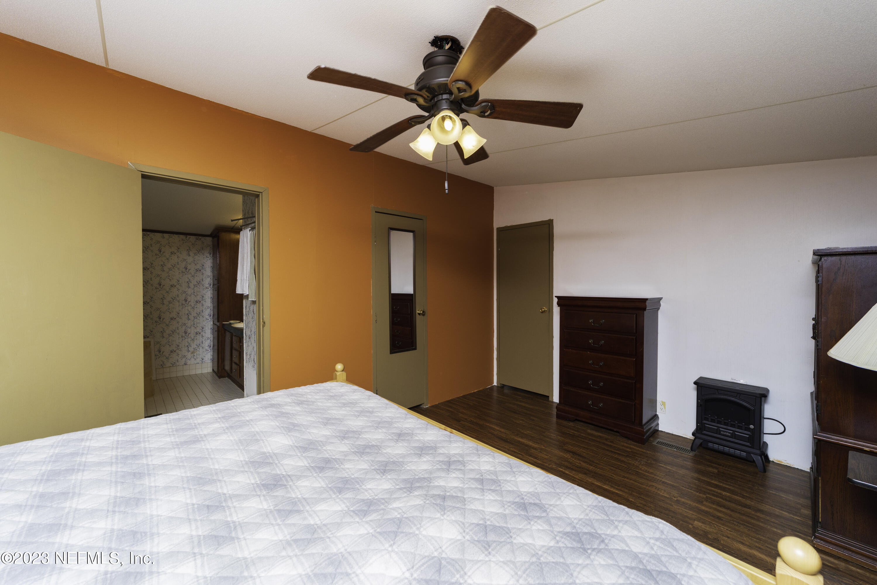 103 Long Branch Court Interlachen, FL 32148 - Photo 50 of 54 a bedroom with a bed and a chandelier
