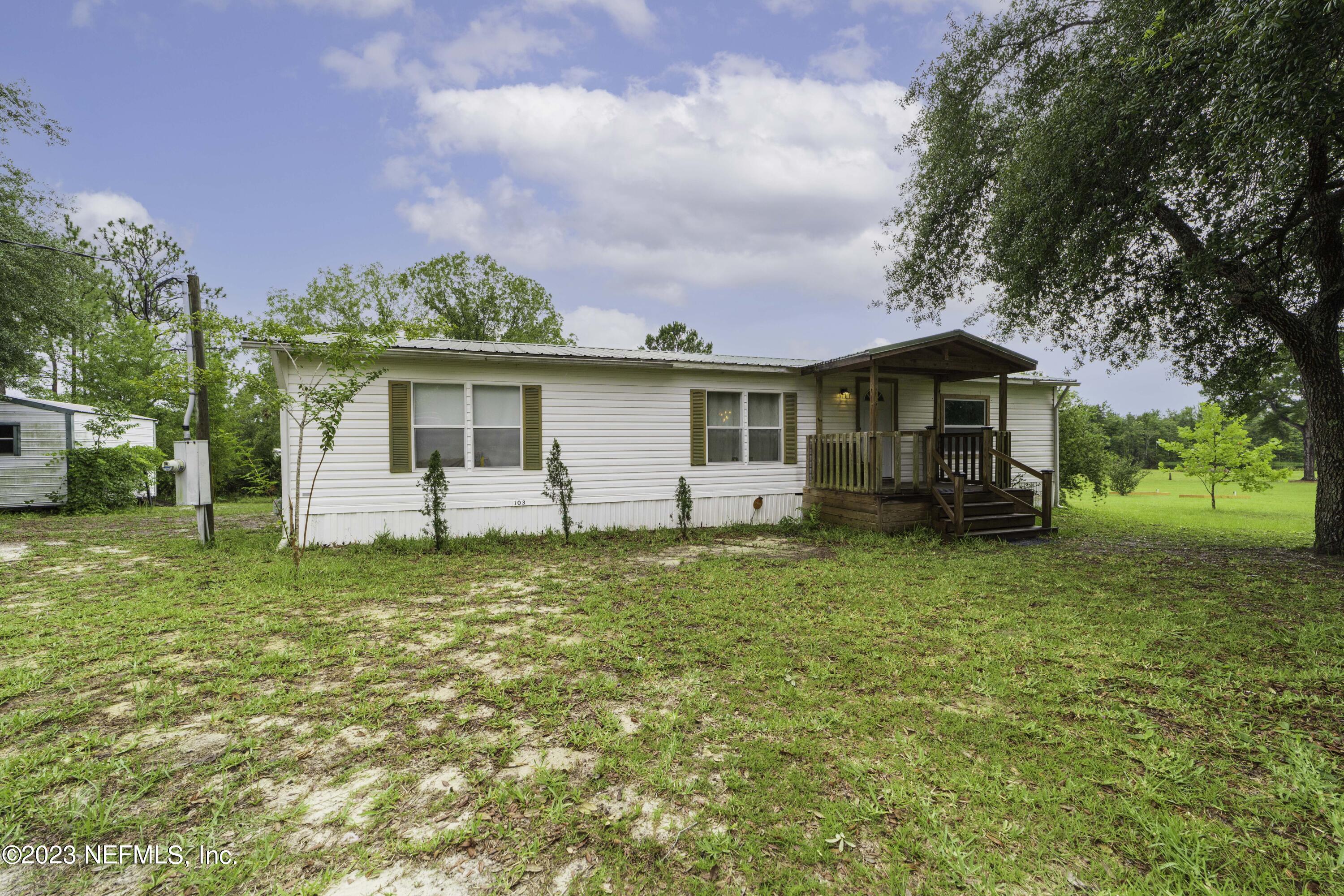 103 Long Branch Court Interlachen, FL 32148 - Photo 6 of 54 a front view of a house with a garden
