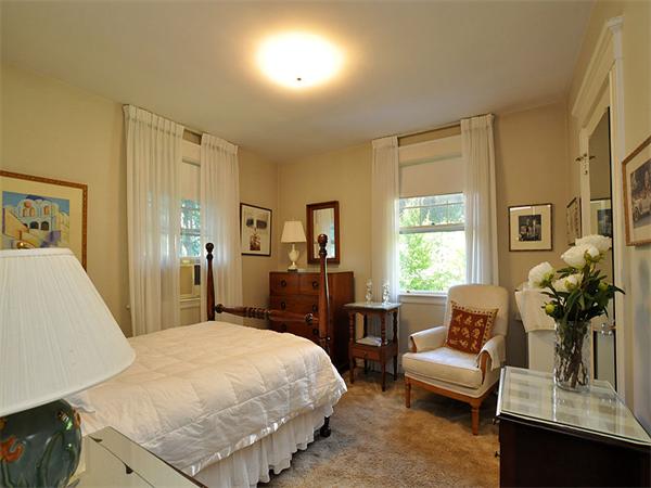 14 Amory Street Brookline, MA 02446 - Photo 14 of 25 a spacious bedroom with a bed a couch and dresser