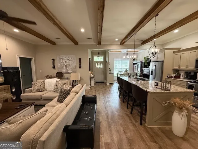 a living room with furniture and a wooden floor