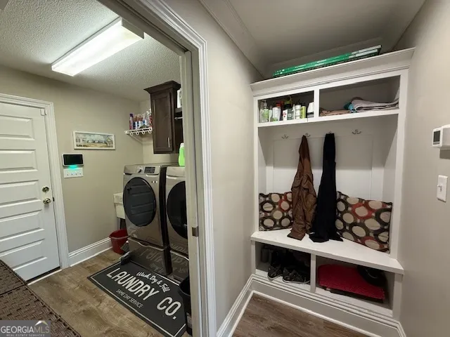 a room with furniture a rug and white walls