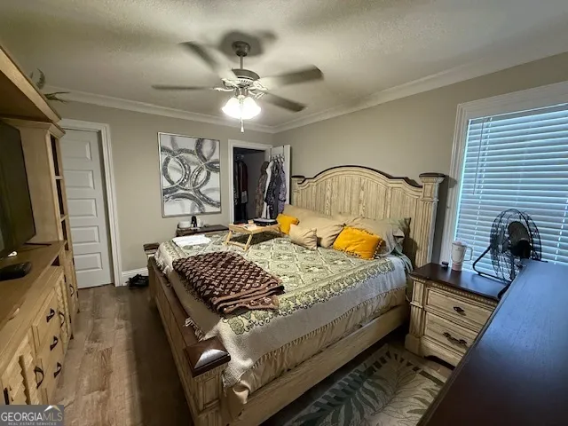 a bed sitting in a bedroom next to a window with pc on the table