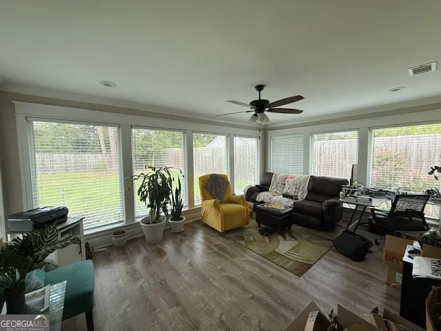 a living room with furniture and floor to ceiling windows