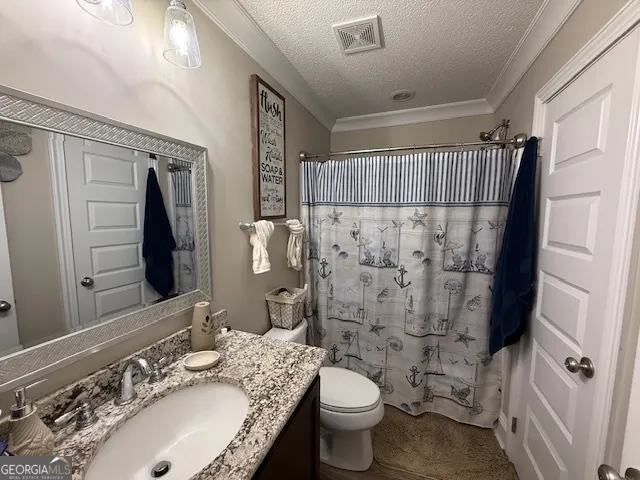 a bathroom with a sink toilet double vanity and shower