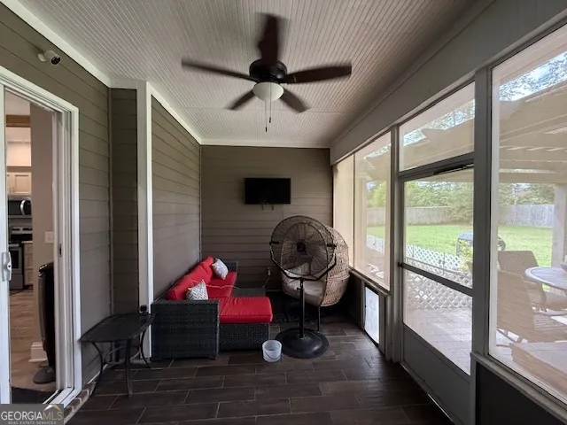 a bedroom with furniture and a large window