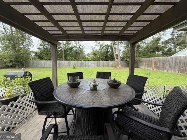 a outdoor dining space with furniture and garden view