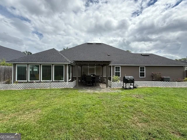 a view of a house with backyard porch and sitting area