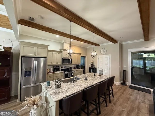 a large kitchen with a table and chairs