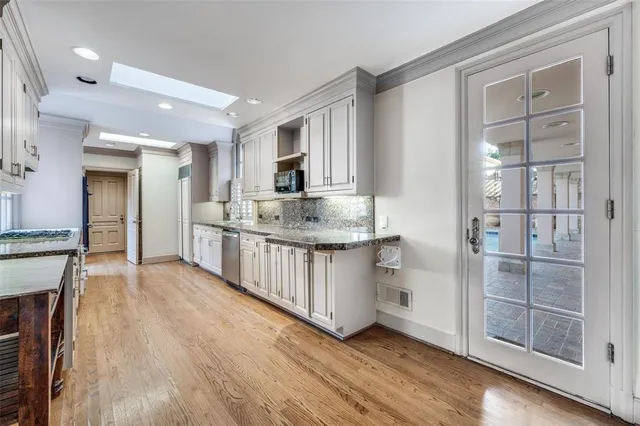 a kitchen with stainless steel appliances granite countertop a sink and cabinets