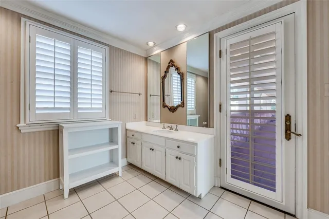 a bathroom with a double vanity sink a mirror and a bathtub