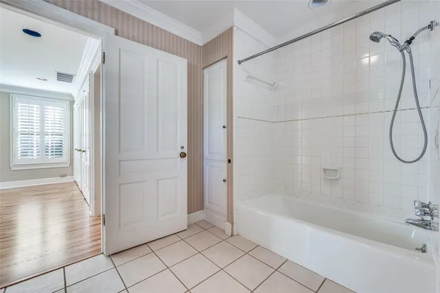 a bathroom with a bathtub and shower