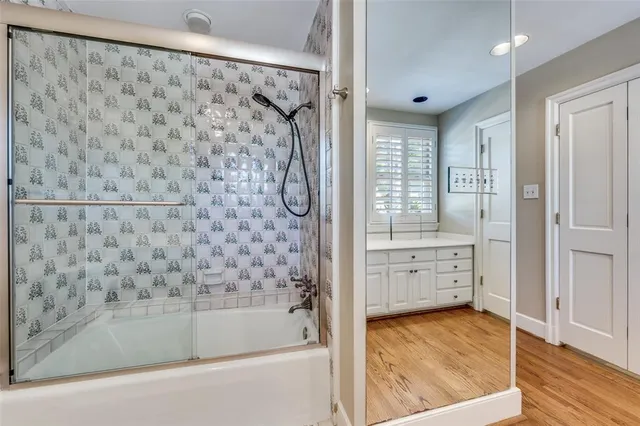 a bathroom with a bathtub and a shower