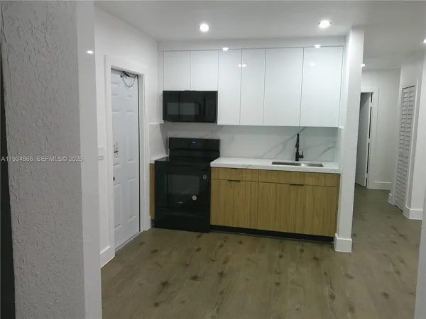 a kitchen with a sink and a refrigerator
