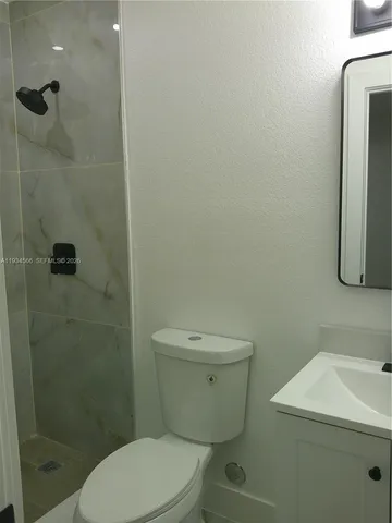 a white toilet sitting next to a bathroom sink