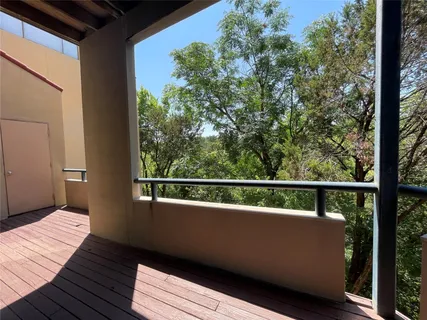 a view of a balcony with wooden floor