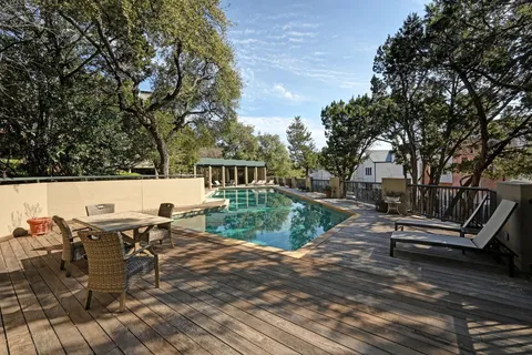 a view of swimming pool with outdoor seating and plants