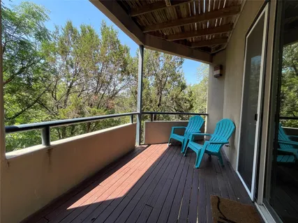 a view of a chair and table in the balcony