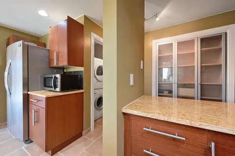 a kitchen with stainless steel appliances granite countertop a refrigerator and a stove