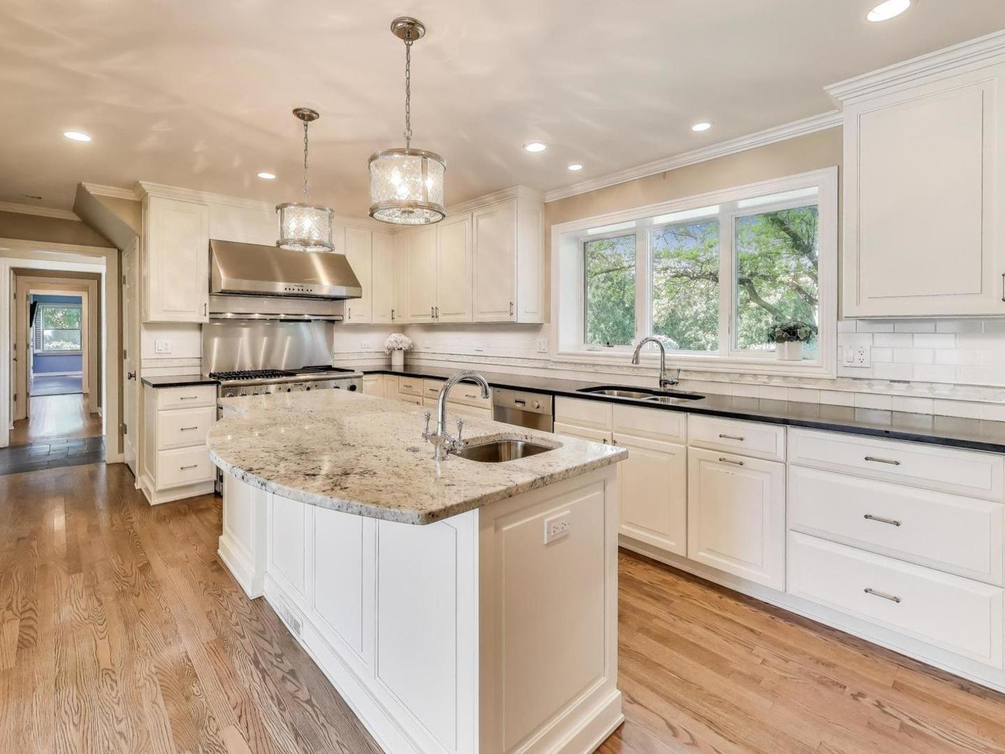 455 Sunset Ridge Road Northfield, IL 60093 - Photo 15 of 47 a kitchen with stainless steel appliances granite countertop a sink a stove and a wooden floors