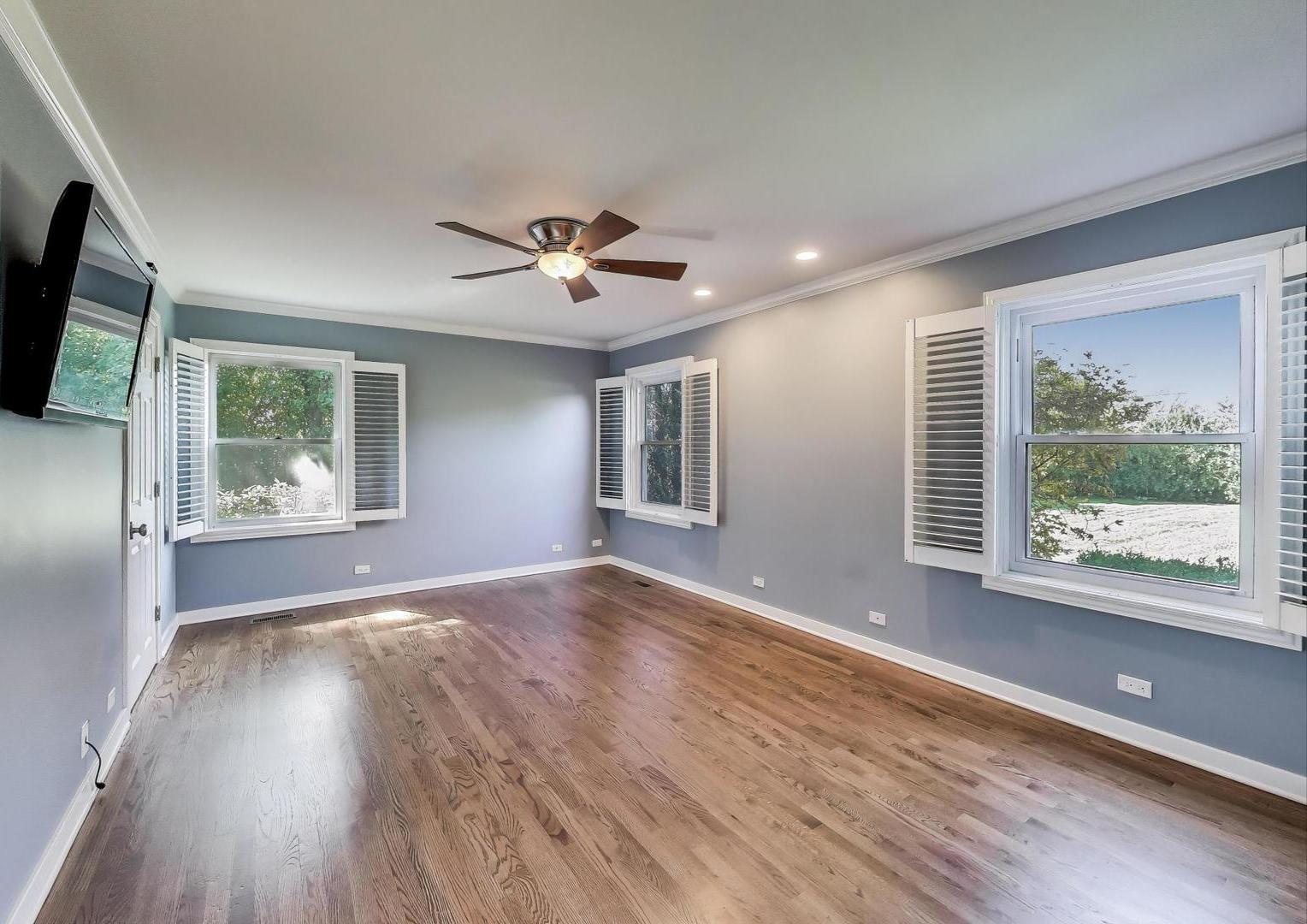 455 Sunset Ridge Road Northfield, IL 60093 - Photo 21 of 47 a view of an empty room with a window and wooden floor