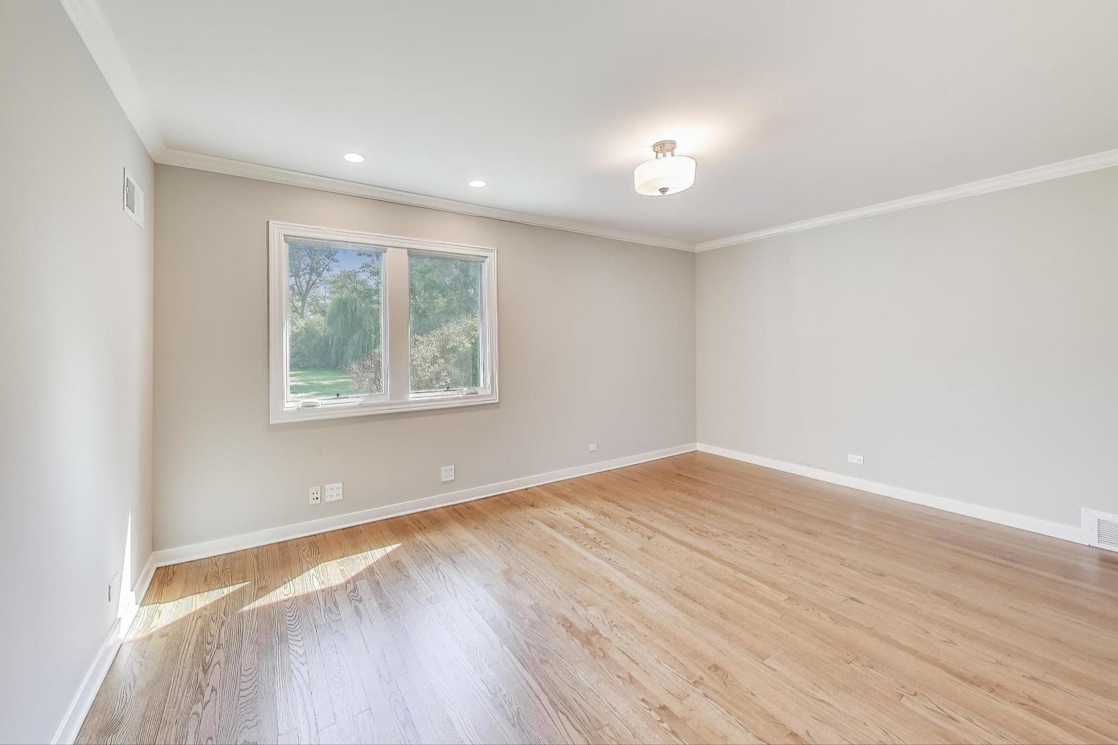 455 Sunset Ridge Road Northfield, IL 60093 - Photo 27 of 47 an empty room with wooden floor and windows