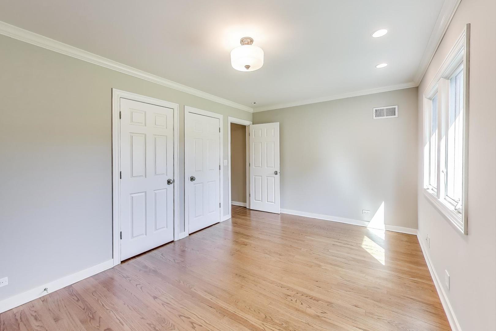 455 Sunset Ridge Road Northfield, IL 60093 - Photo 28 of 47 a view of an empty room with wooden floor and a window