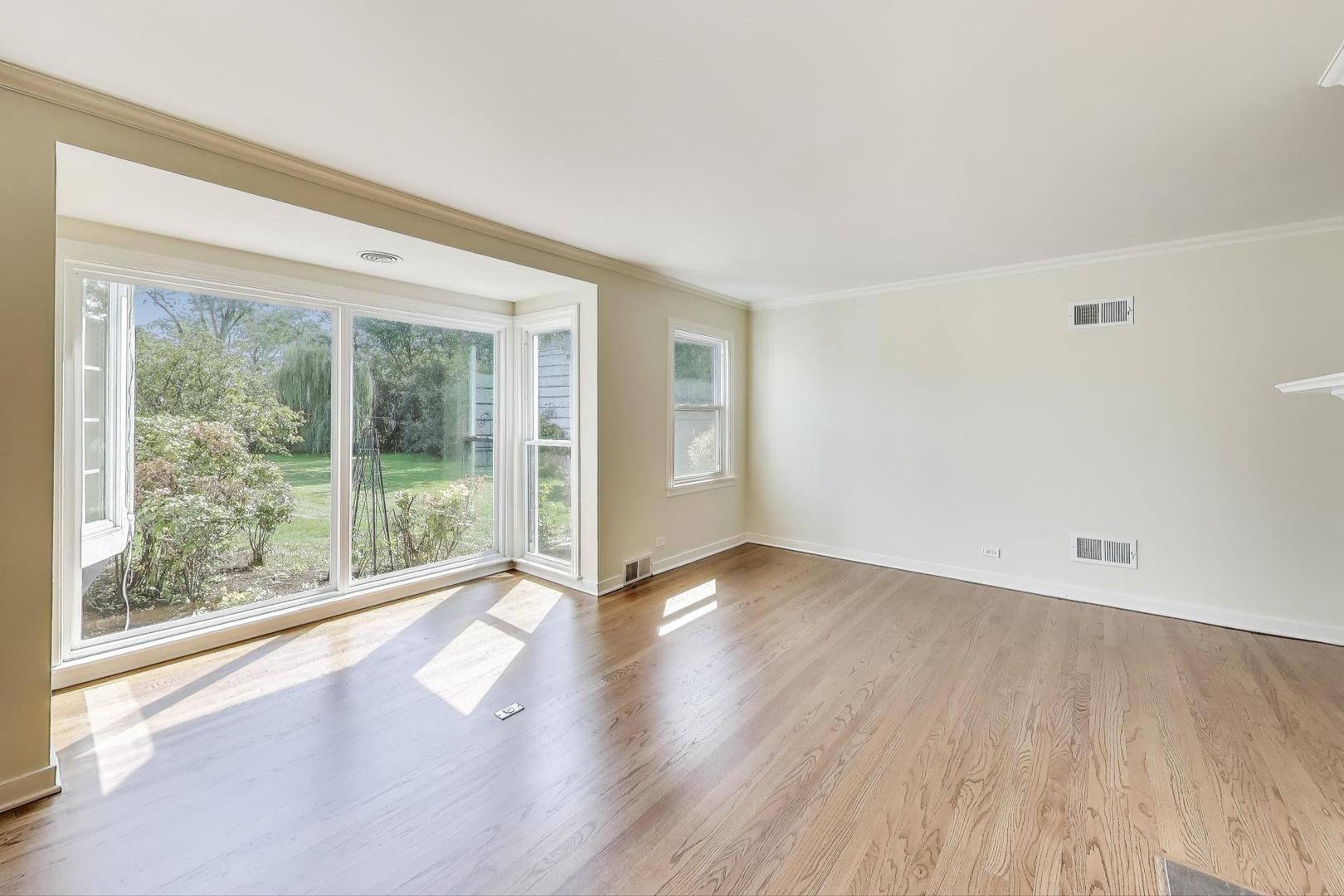 455 Sunset Ridge Road Northfield, IL 60093 - Photo 8 of 47 a view of an empty room with wooden floor and a window