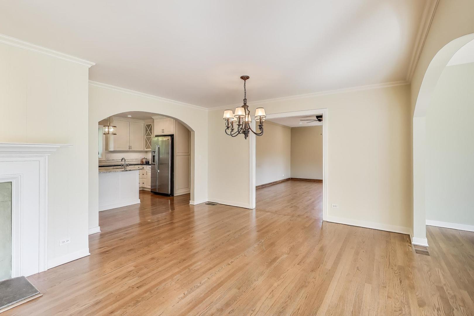455 Sunset Ridge Road Northfield, IL 60093 - Photo 9 of 47 a view of a kitchen with wooden floor and a ceiling fan