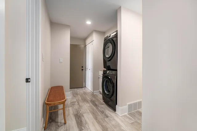 a storage room with wooden floor washer and dryer